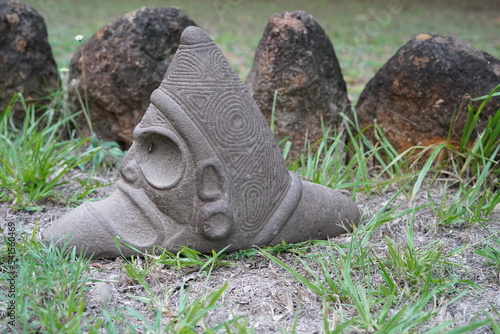 Obraz na plátně Taino Antique Stone Cemi Idol Figure sitting on the ground on top of grass