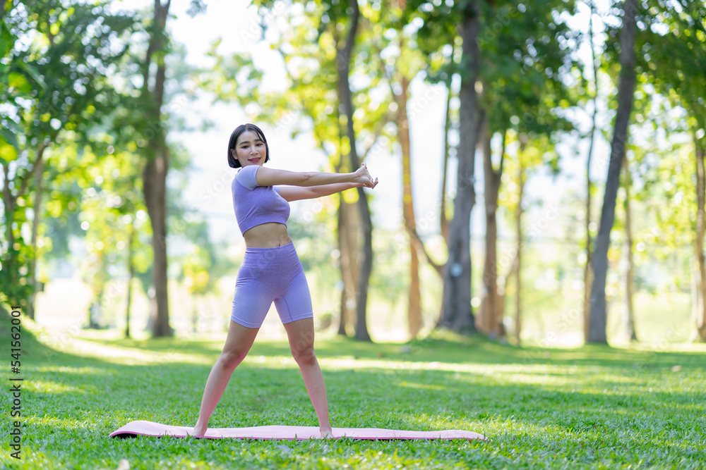 Attractive and strong Asian woman with a beautiful body. yoga in graceful posture in the green park Modern concept of relaxation and health care. Attractive and strong Asian woman with a beautiful body. yoga in graceful posture in the green park Modern concept of relaxation and health care.