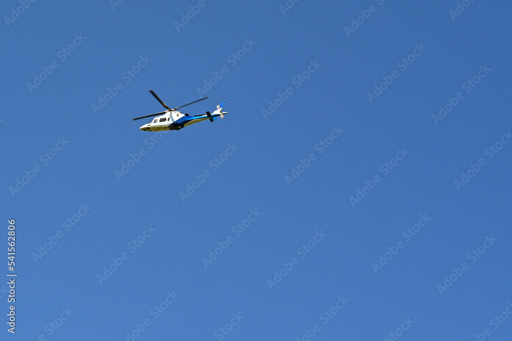 Unmarked executive helicopter in flight against a deep blue sky. No people. Copy space. Unmarked executive helicopter in flight against a deep blue sky. No people. Copy space.