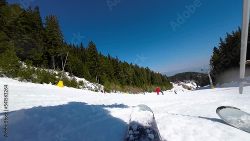 Skiing. Action camera of skier going downhill on alpine ski on snow slopes in the mountains. Man going downhill on ski having fun on slopes. Winter sport outdoor activity video