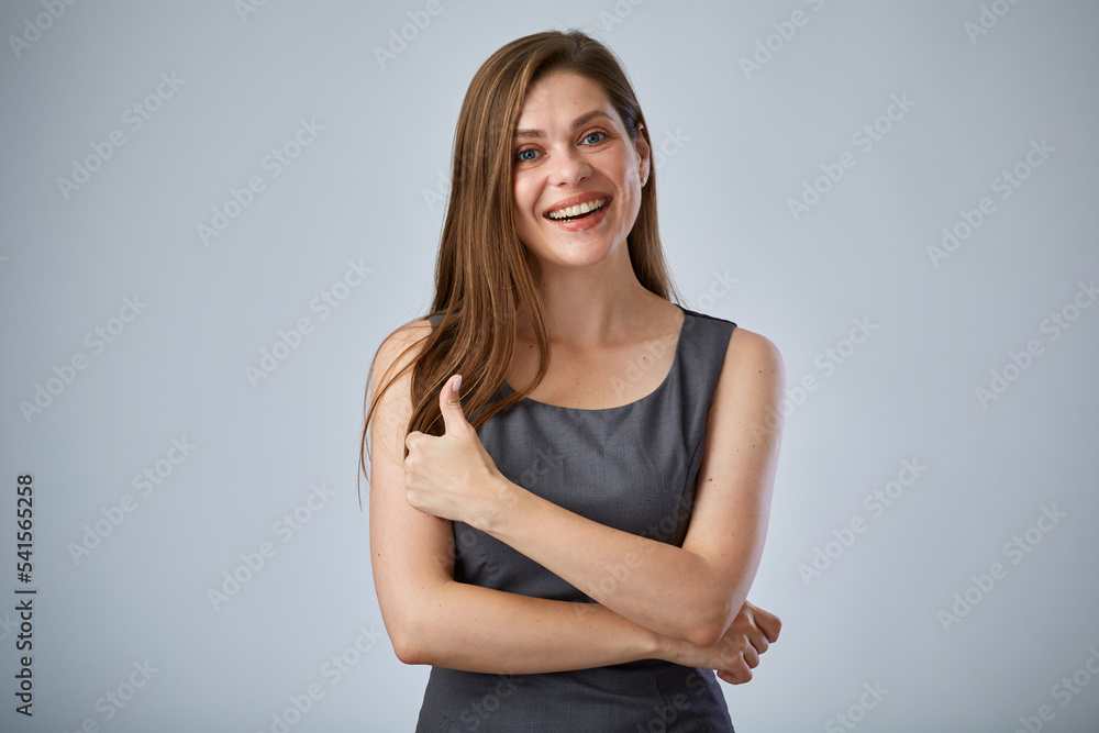 Obraz premium Smiling woman in gray business dress showing thumb up. like symbol. isolated advertising portrait.