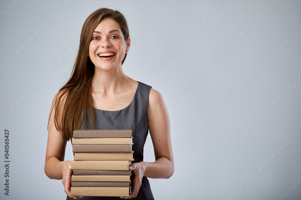 Smiling student holding pile of books or workbooks. Isolated advertising portrait. Smiling student holding pile of books or workbooks. Isolated advertising portrait.