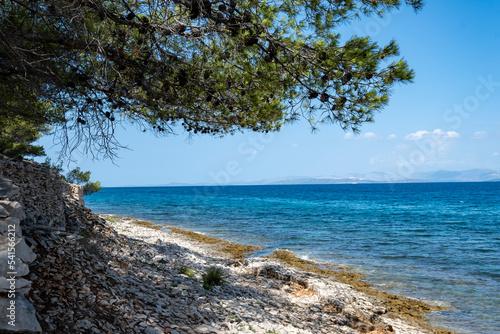 Beautiful blue, turquoise sea and stone dry wall built on the edge of the coast at Brac island, Croatia