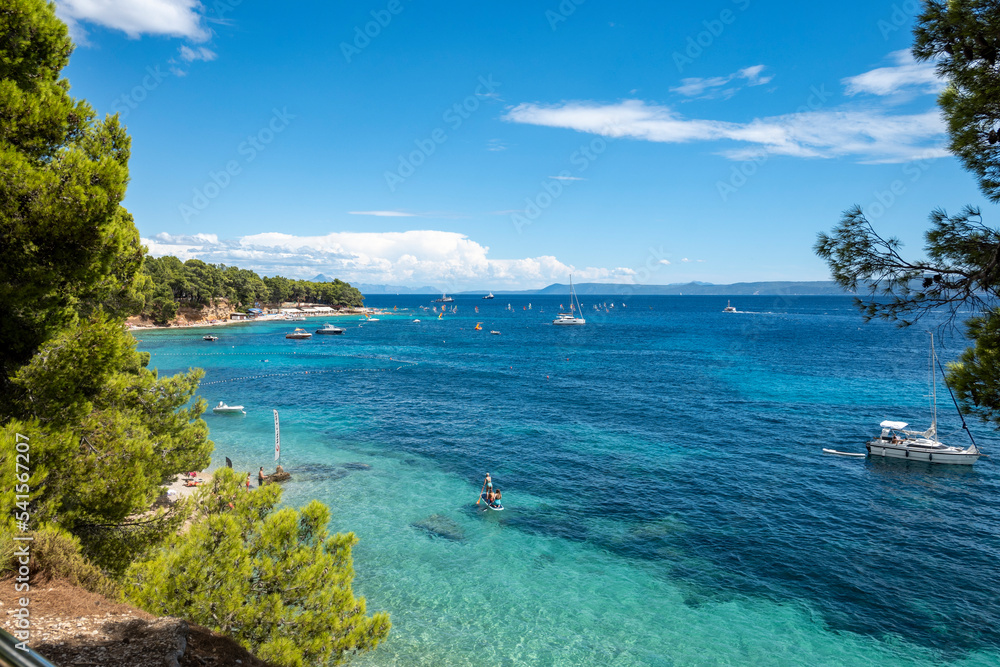 People enjoying summer season on Brac island, Croatia in turquoise, crystal clear adriatic sea