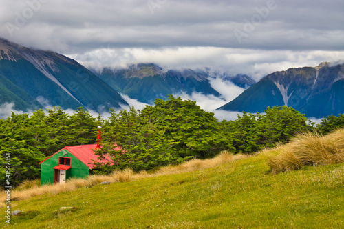 The historic Bushline Hut (1934) on Mount Robert, Nelson Lakes National Park, South Island, New Zealand, with a view of the cloud covered Saint Arnoud Range
 photo