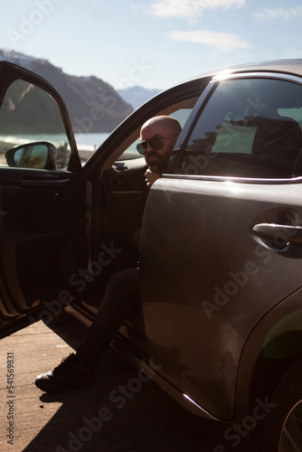 bald man in a car