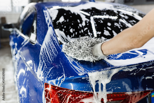Fotografi Car washer doing manual foam washing in auto detailing service