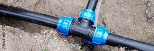 Fotografie Installed PVC water pipes are assembled and laid in trench at construction site