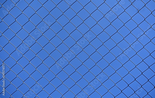 blue sky through a metal lattice. background. ecology concept