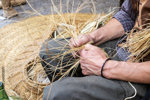 closeup of the hands of a basket maker showing how baskets and wicker products are made. handicrafts concept
