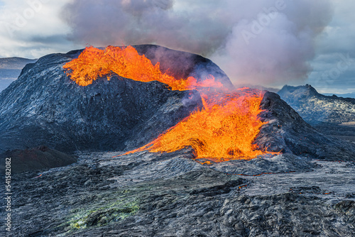 volcano during an eruption. strong lava flow from the volcanic crater in iceland. Volcanic landscape on Reykjanes Peninsula in GeoPark. View of crater with heavy smoke development