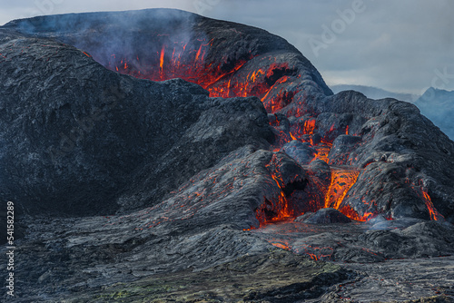 Details of a volcanic crater. Crater opening from the side. some lava from the crater of a volcano on Iceland. Landscape on Reykjanes Peninsula in GeoPark. Heavy smoke over the crater