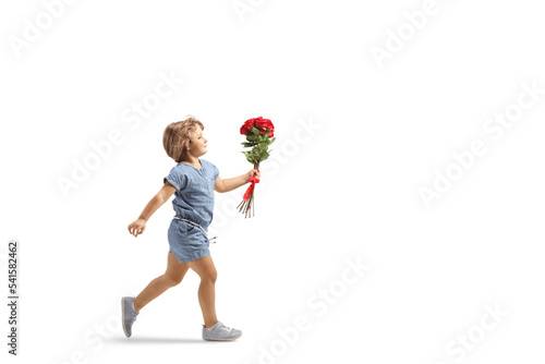 Full length profile shot of a little girl running with red roses in her hand