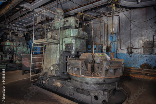 Stopped production of cylinder blocks for cars in an old factory. Large machine in the workshop