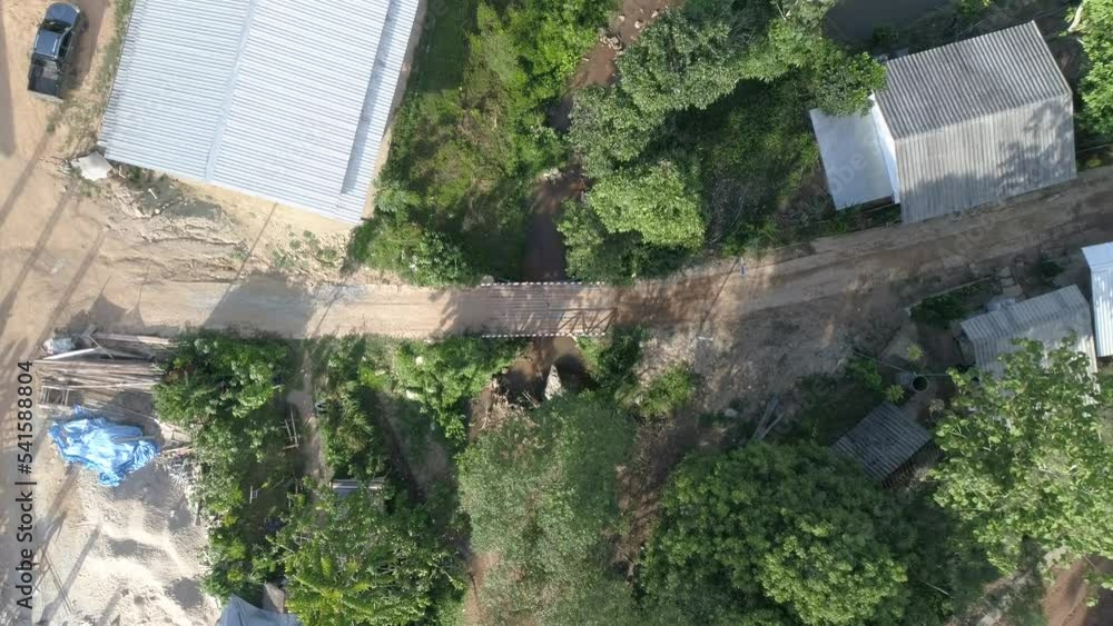 A small wooden old bridge is placed over a small stream in a village in Omkoi district, Chiangmai, Thailand. May 2021. A small wooden old bridge is placed over a small stream in a village in Omkoi district, Chiangmai, Thailand. May 2021.