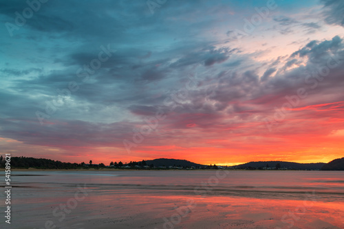 Colourful cloud filled sunrise at the seaside