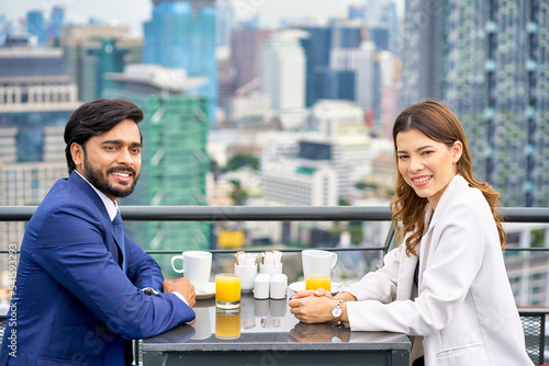 Happy lunch of Couple of businessman and woman , Luxury meal on rooftop restaurant cityscape view photo