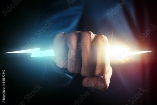 Strong hands catching thunderbolt - Power concept