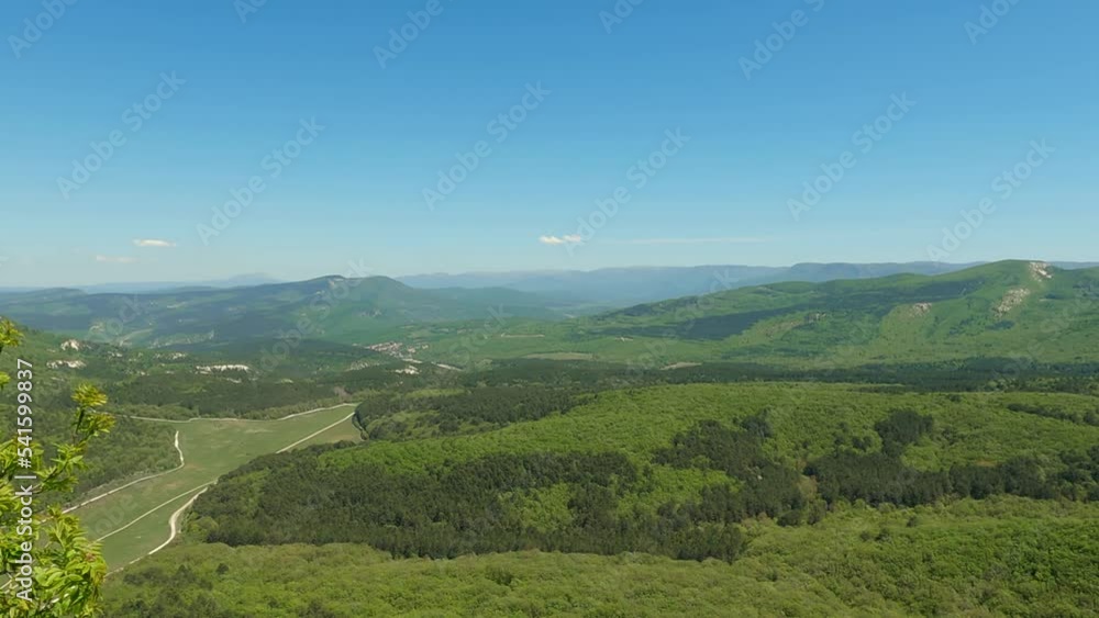 Tourist arm hand show the territory of a mountain green valley. Man on the viewpoint demonstrate to the landscape. He point out to the horizon with his palm Tourist arm hand show the territory of a mountain green valley. Man on the viewpoint demonstrate to the landscape. He point out to the horizon with his palm