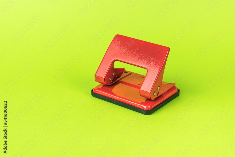 Classic red hole punch on a light green background. Classic red hole punch on a light green background.