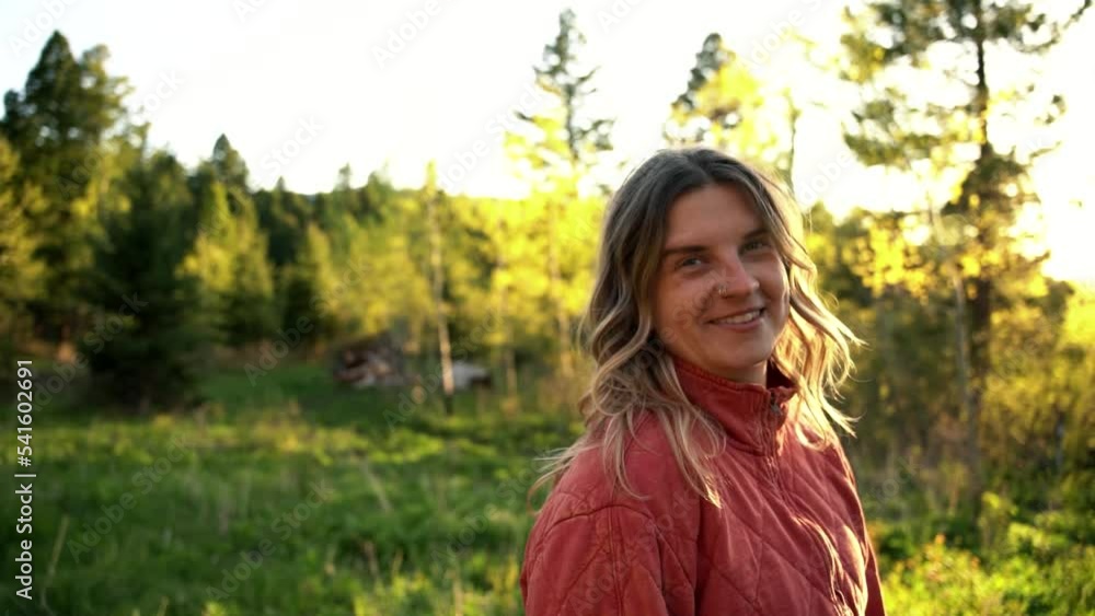 Soulful content woman living at countryside Montana woods flipping hair Soulful content woman living at countryside Montana woods flipping hair