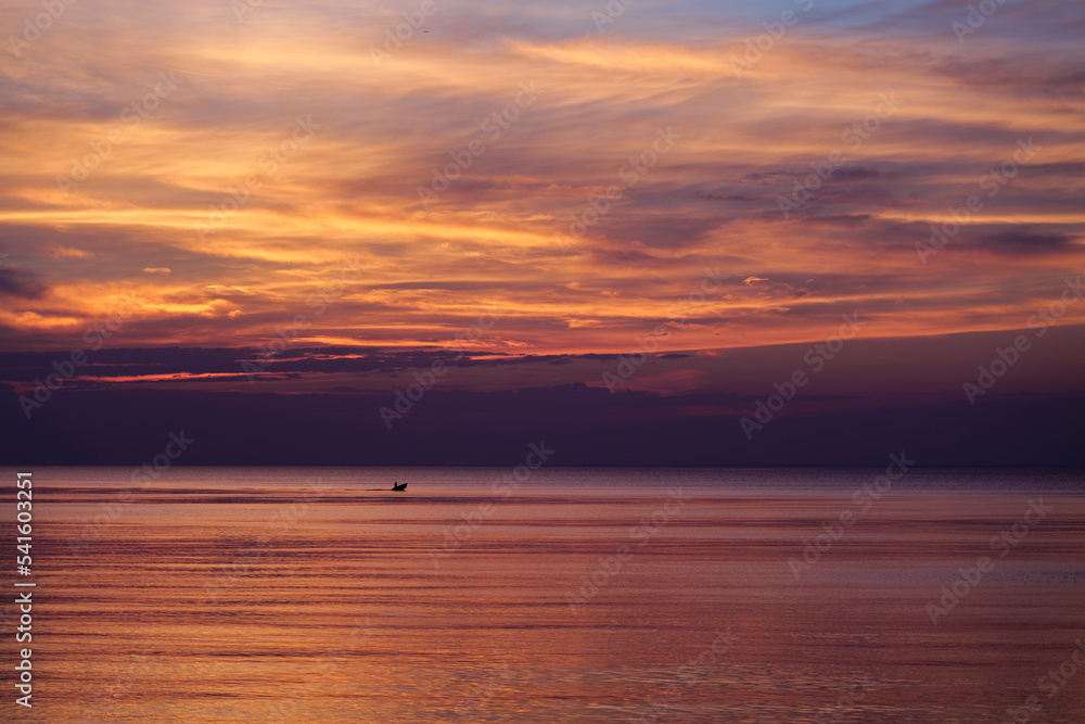 The dramatic sky during colorful red and purple sunset over the ocean on the outer banks of Long Island New York. High-quality photo The dramatic sky during colorful red and purple sunset over the ocean on the outer banks of Long Island New York. High-quality photo