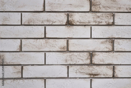a white brick wall with dirty streaks. brick background
