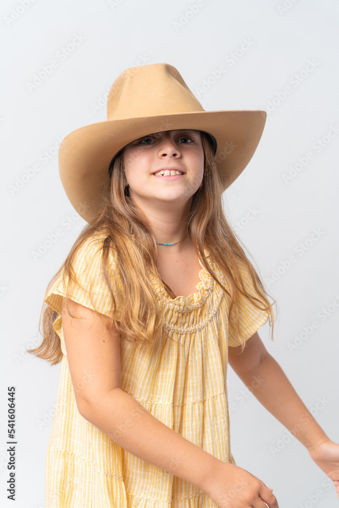 Stylish young girl in yellow dress and orang hat Stylish young girl in yellow dress and orang hat