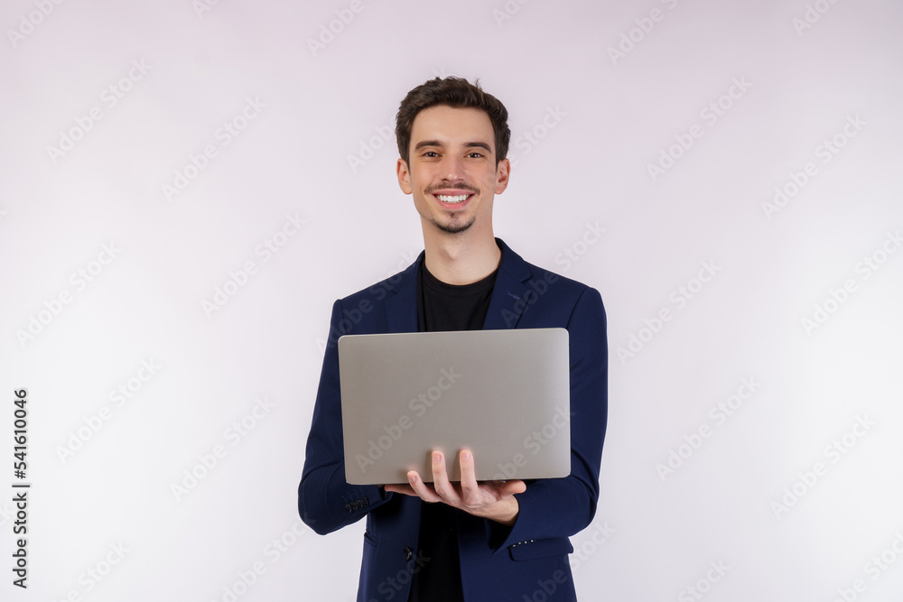 Portrait of young handsome smiling businessman holding laptop in hands, typing and browsing web pages isolated on white background Portrait of young handsome smiling businessman holding laptop in hands, typing and browsing web pages isolated on white background