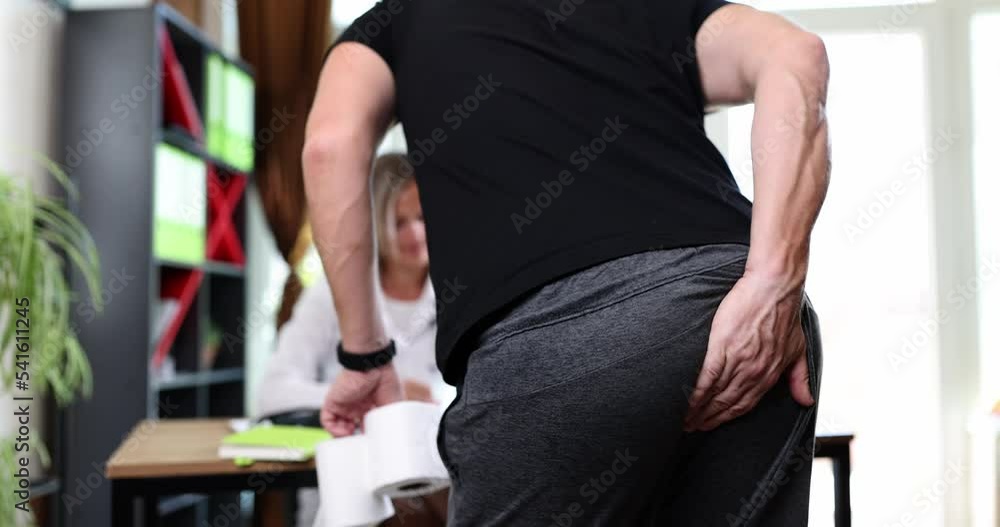 Man with symptoms of hemorrhoid constipation and diarrhea at doctor appointment Man with symptoms of hemorrhoid constipation and diarrhea at doctor appointment