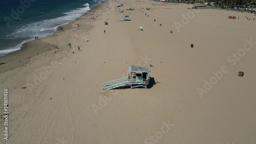 Aerial shot of lifeguard towers and beachgoers at Santa Monica State Beach in California