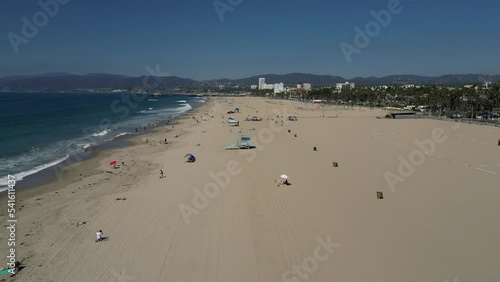 Aerial shot of lifeguard towers and beachgoers at Santa Monica State Beach in California