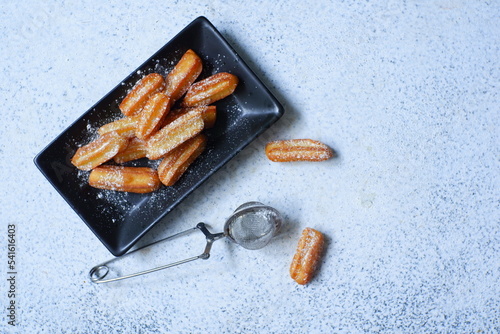 churros in a plate  against white background 