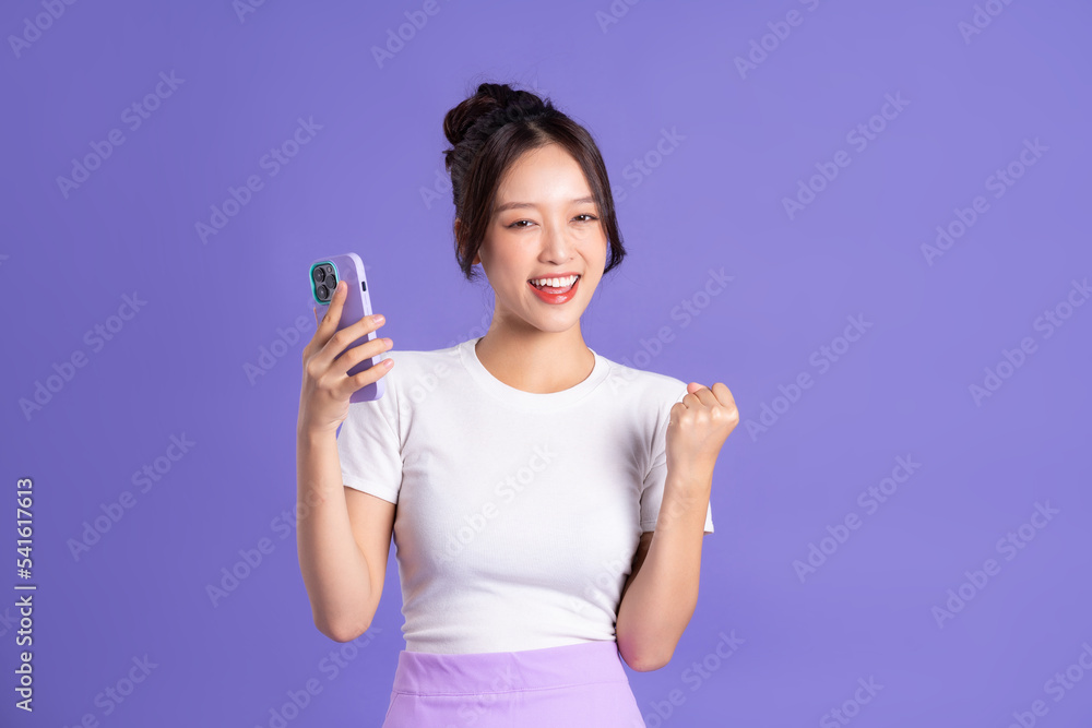 Portrait of a beautiful Asian woman posing on a purple background Portrait of a beautiful Asian woman posing on a purple background