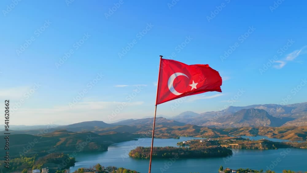 Red Turkish flag in the foreground. Beautiful Green Lake in Manavgat in the background. Leisure time activities in Turkey. . High quality 4k footage