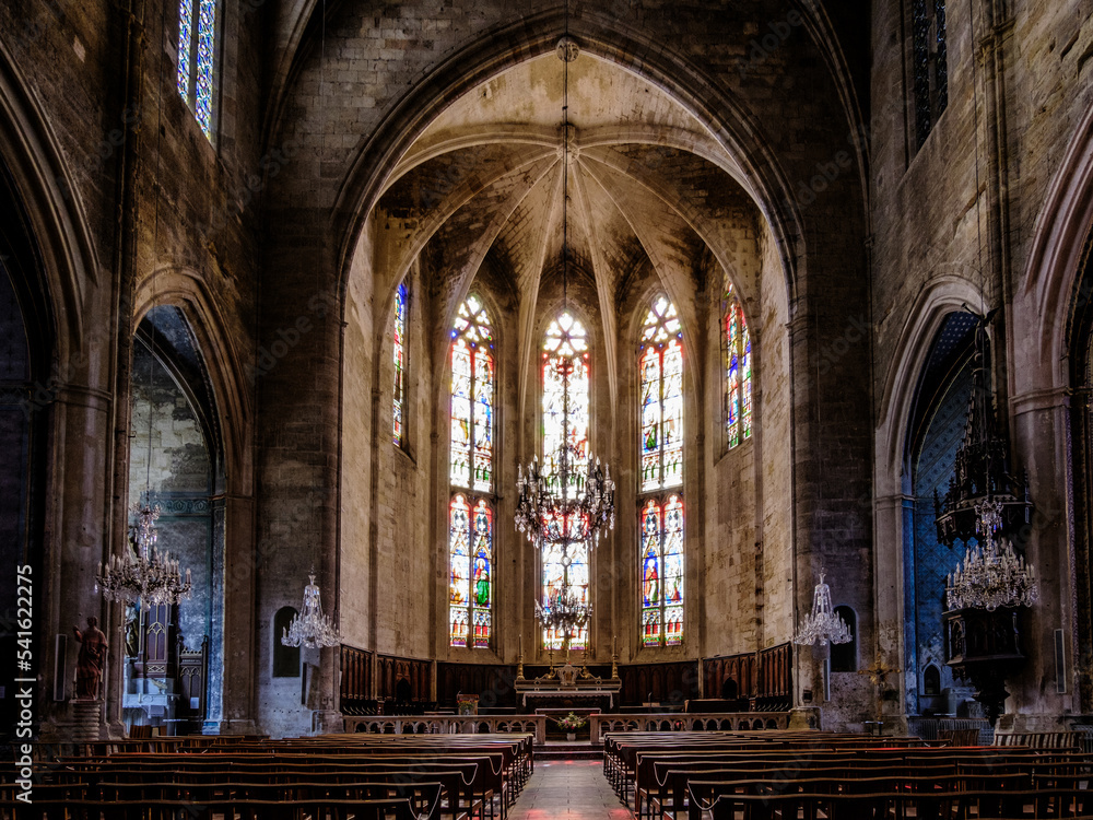 Interior, cross ribbed vault and stained glass of the gothic Saint Etienne collegiate church of Capestang, in the South of France (Herault)