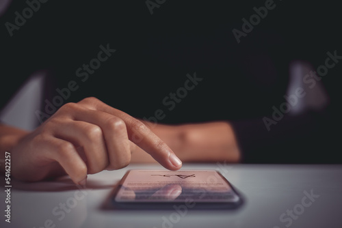 Woman finger signing contract on mobile phone screen. Concept of signing legally binding contracts through paperless remote communication tools.