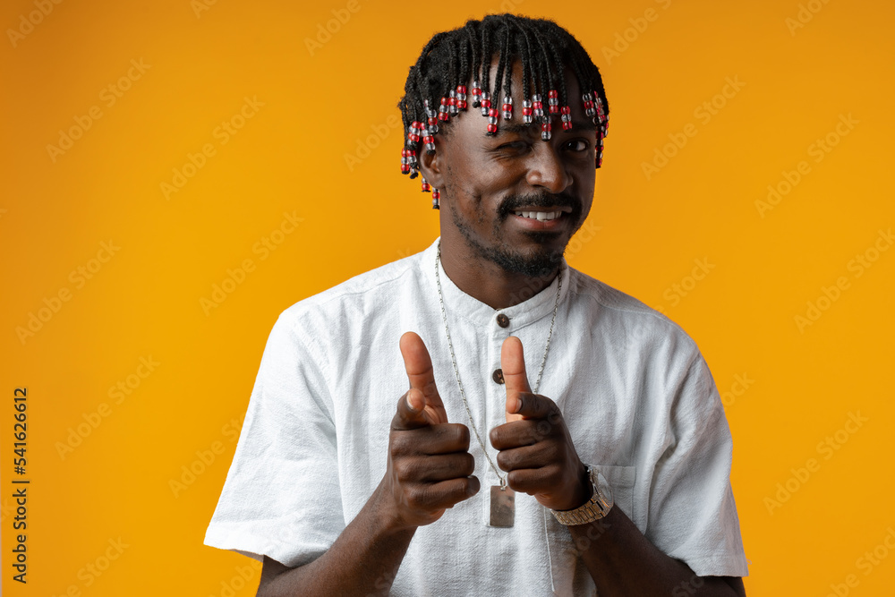 Young african man pointing to camera with fingers isolated on yellow background