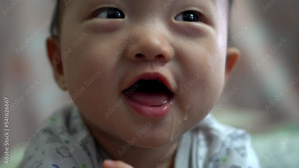 Baby boy happily look at camera with drop of drool Baby boy happily look at camera with drop of drool