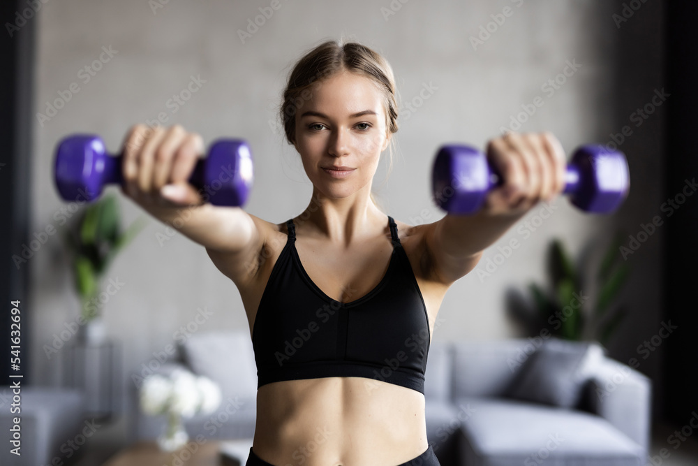 Active sportive woman with dumbbells pumping up muscles biceps concept fitness sport training lifestyle Active sportive woman with dumbbells pumping up muscles biceps concept fitness sport training lifestyle