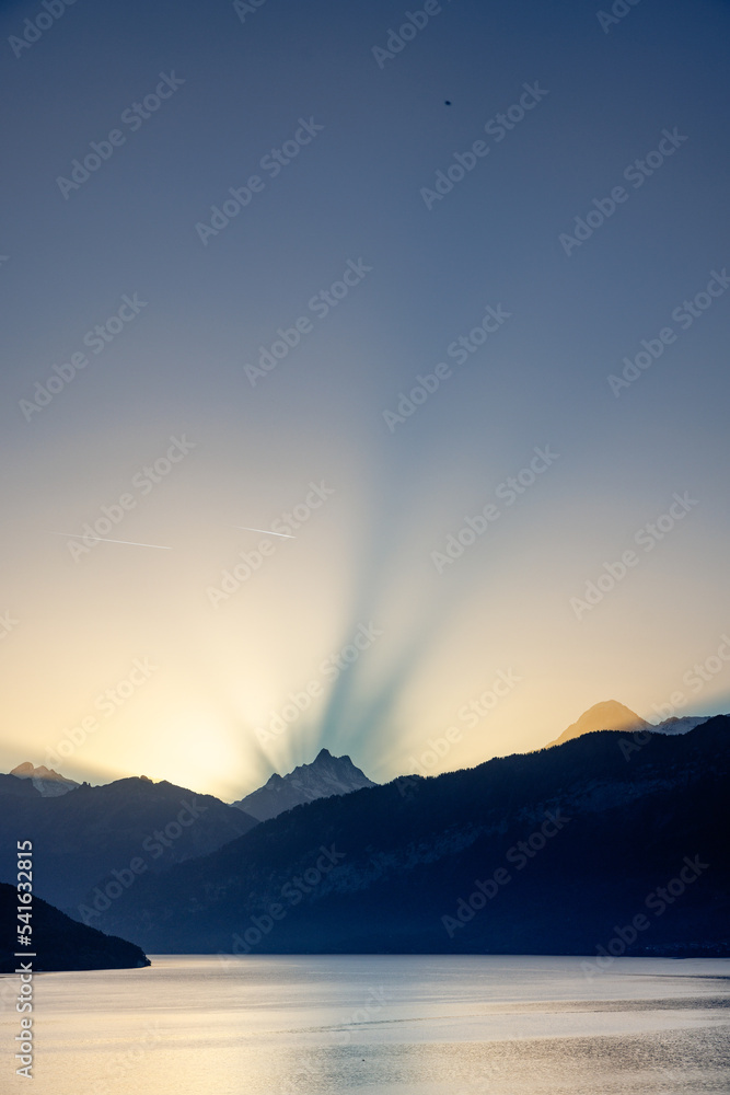 autumn sunrise behind Schreckhorn in the Bernese alps creating halo effect