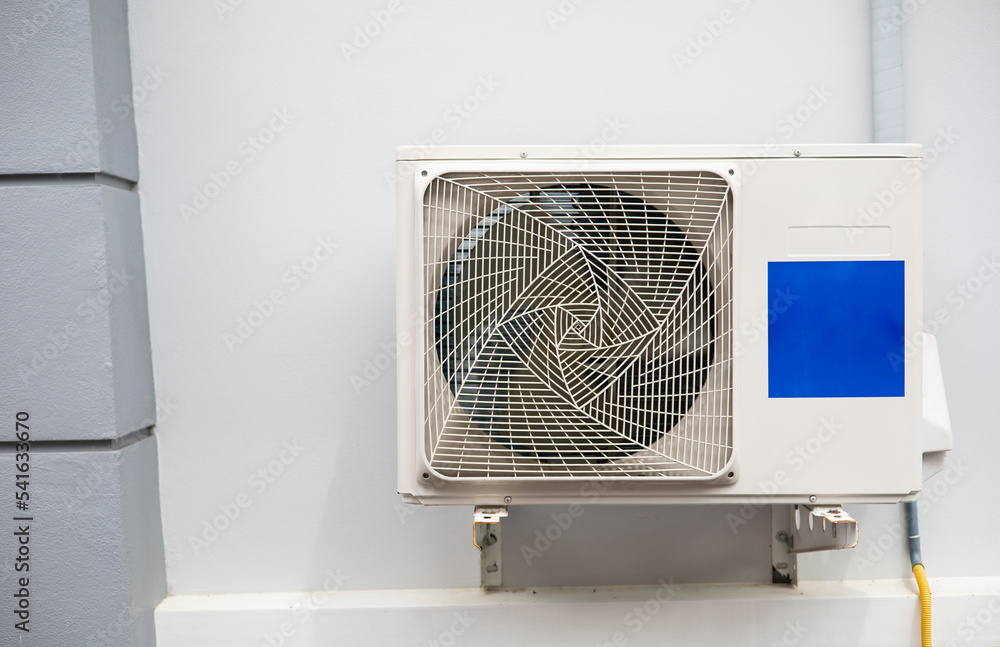 The air conditioner's cooler is mounted on the white wall of the house. The air conditioner's cooler is mounted on the white wall of the house.