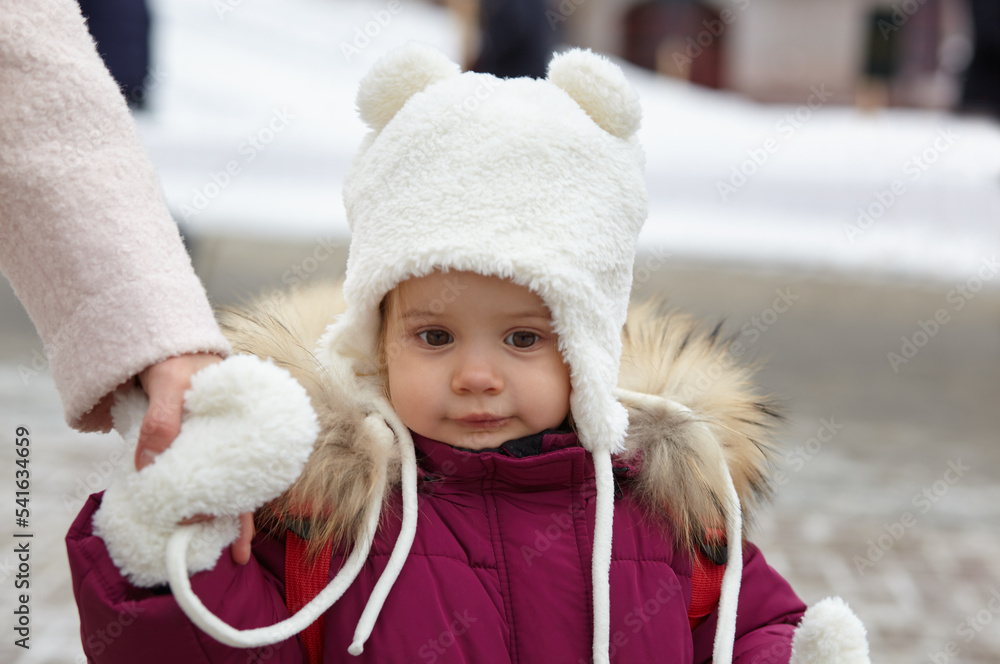 Mother and daughter are walking around the city on Christmas and New Year holidays. Parent and little child having fun outdoors Mother and daughter are walking around the city on Christmas and New Year holidays. Parent and little child having fun outdoors