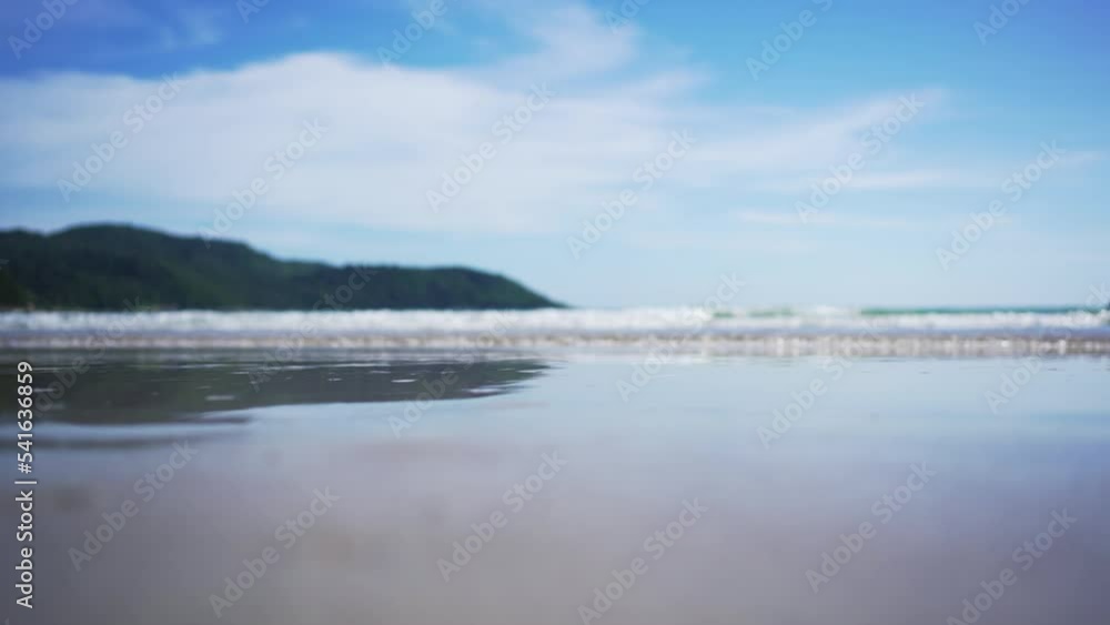 Panorama white sand popular beach waves texture lapping across untouched shore. Panorama white sand popular beach waves texture lapping across untouched shore.
