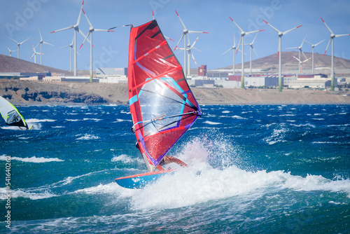 Two people windsurfing with wind turbines in the background, Pozo Izquierdo, Gran Canaria, Canary Islands, Spain photo