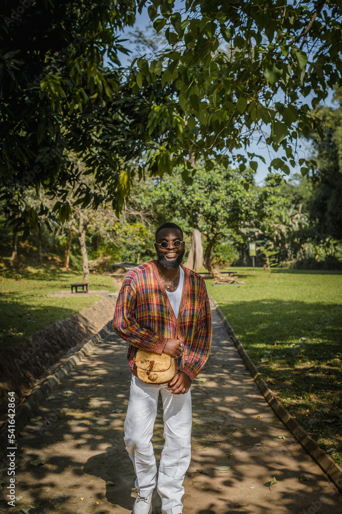 A black man taking a walk in the park A black man taking a walk in the park