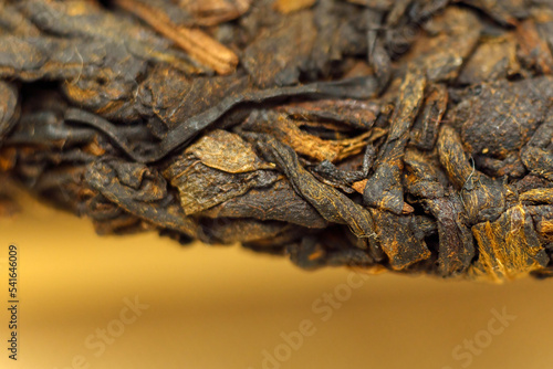 Pressed Chinese fermented Pu erh tea. Macro close up. Aromatic black puer tea. Selective focus © Алексей Филатов