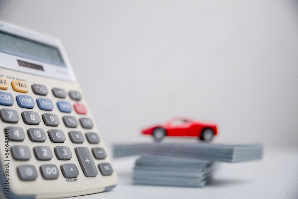 Concept of car insurance business, saving buy - sale with tax and loan for new car. Car toy vehicle with stack coin money on background. Planning to manage transportation finance costs. loan for car Concept of car insurance business, saving buy - sale with tax and loan for new car. Car toy vehicle with stack coin money on background. Planning to manage transportation finance costs. loan for car