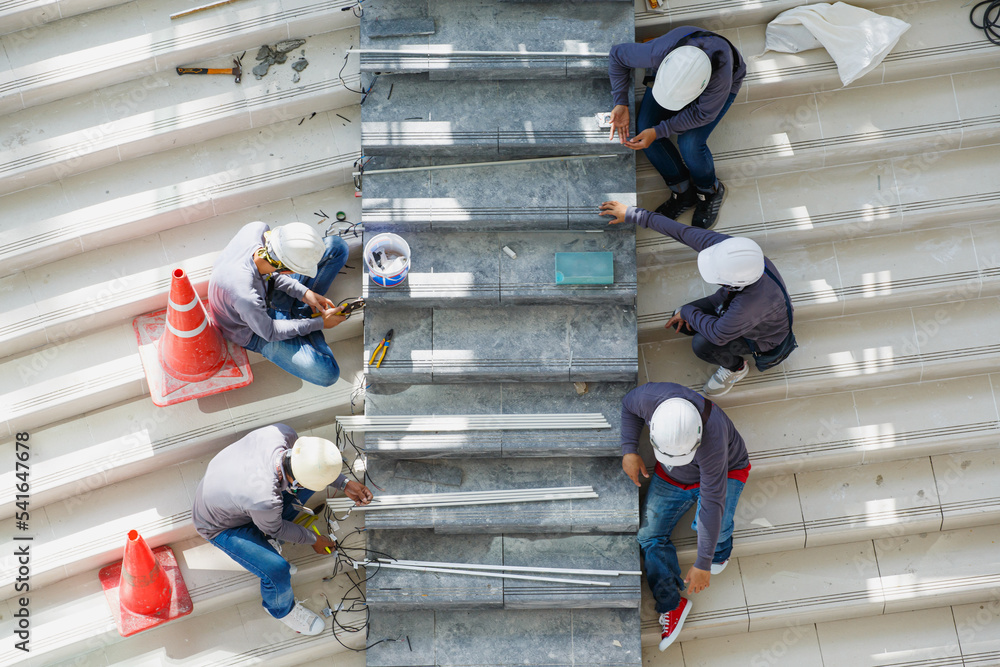 Workers install granite ladder on the unfinished building supermarket
