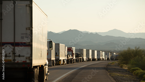 A row of trucks bumper to bumper on a road, San Bernardino, California, USA photo